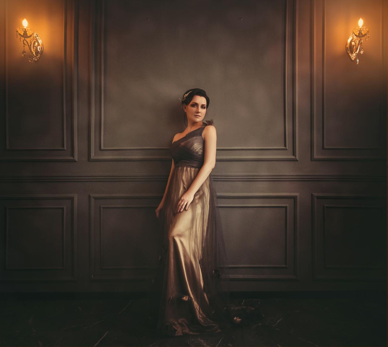 A sophisticated portrait of a woman in an elegant evening gown, captured in a luxurious indoor setting.